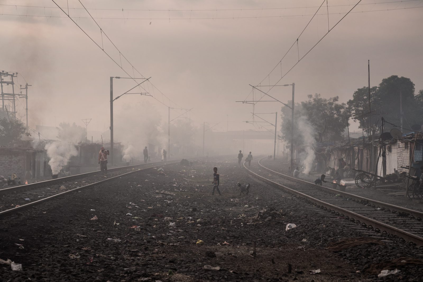 Smoke from coal-burning chulas shrouds an urban slum in Madhya Pradesh
