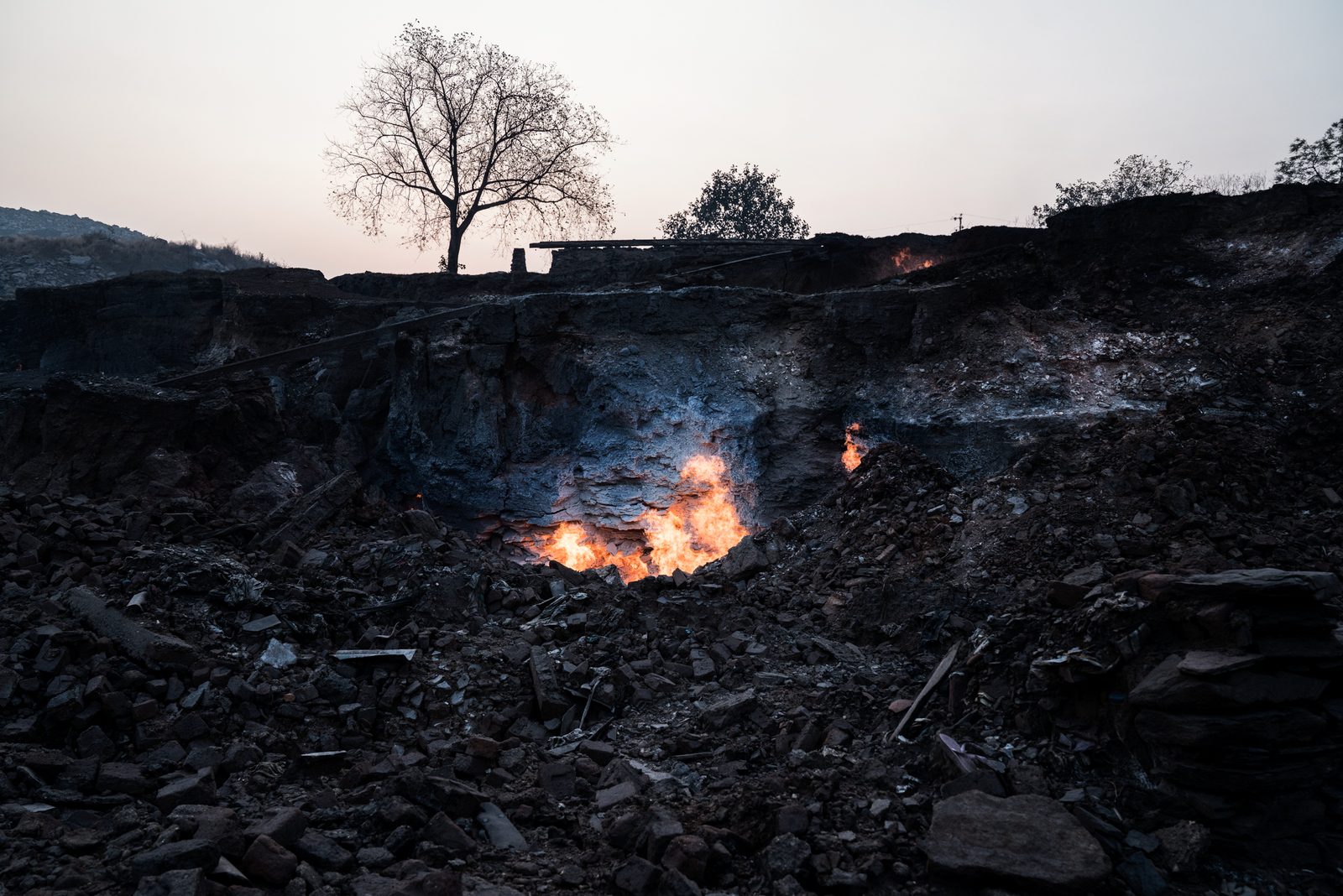 The flames from an underground coal-seam fire emerge frmo a crack where a village once stood