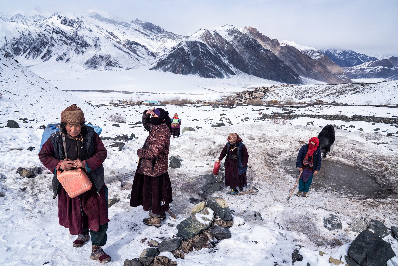 The women of Kumik walk up the mountainside to access the spring and collect water