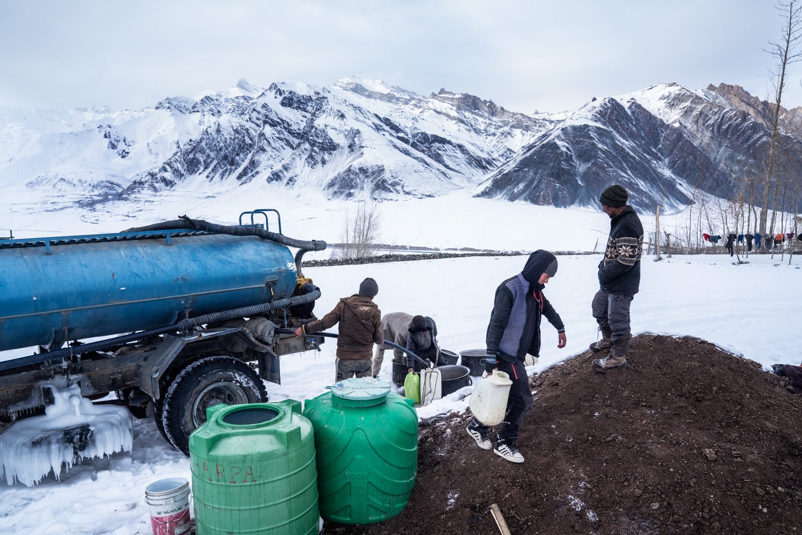 The villagers of Kumik collect water from the government water tanker