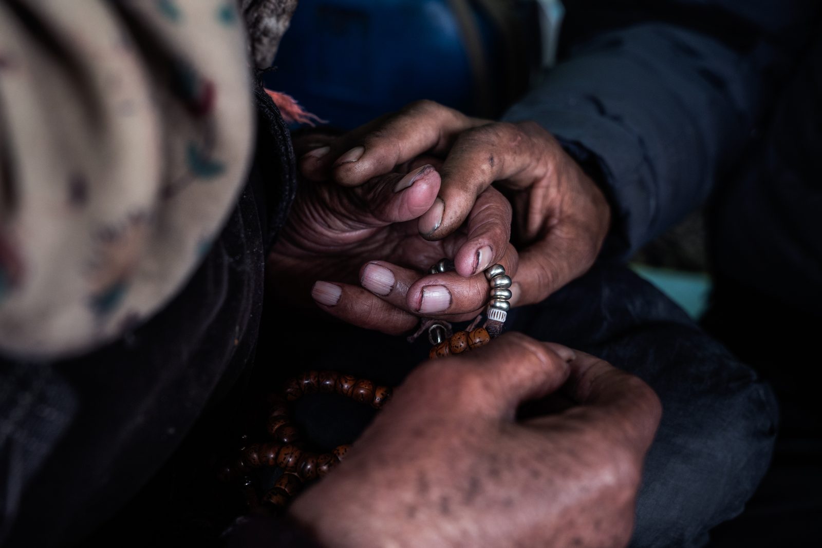 Tanzin Rigzin holds the hand of Lobsang Dolma, a blind village elder, as she recals memories of first arriving in Kumik after marraige