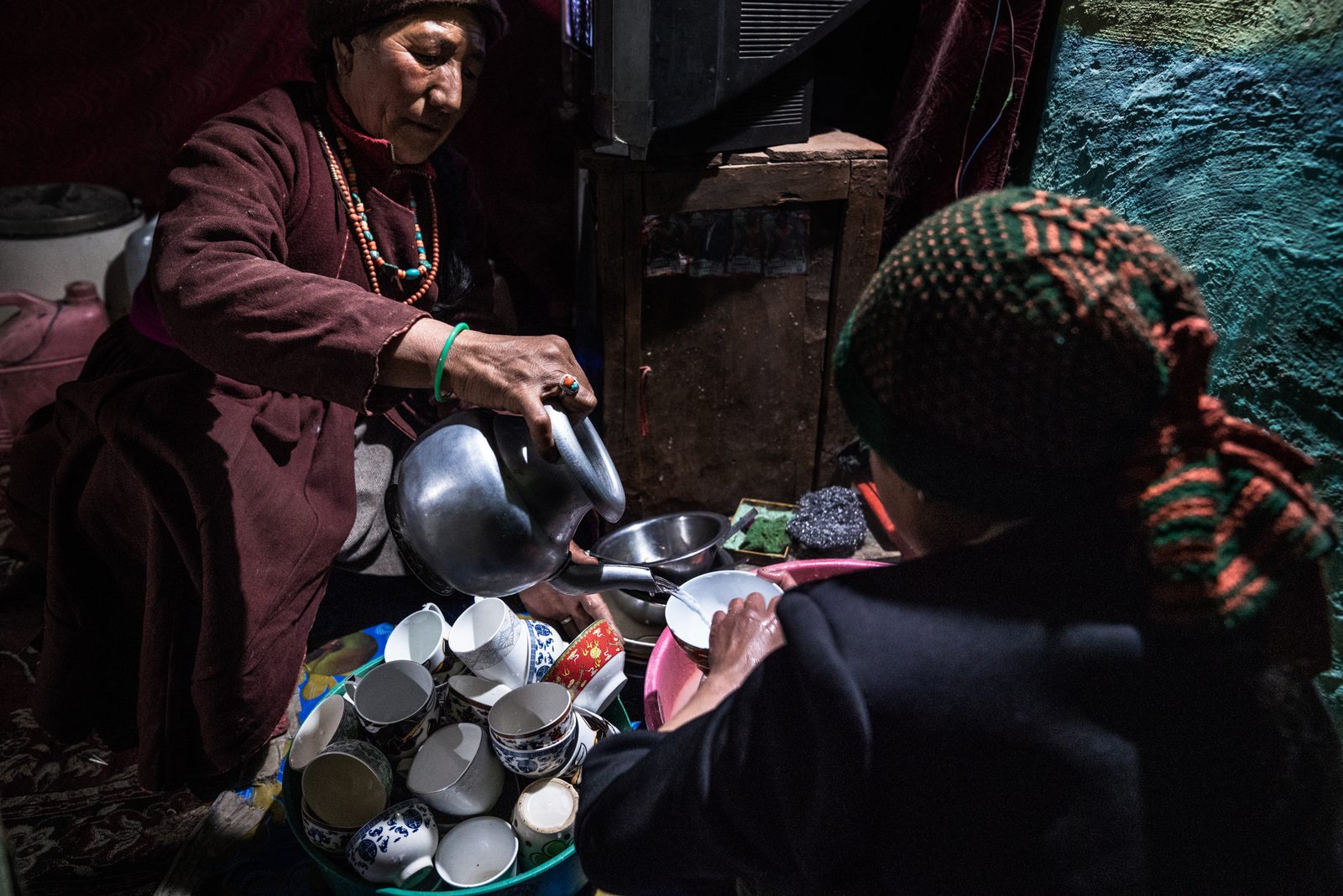 Sonam Putit and Tenzin Yangdoll wash the dishes afer a village gathering