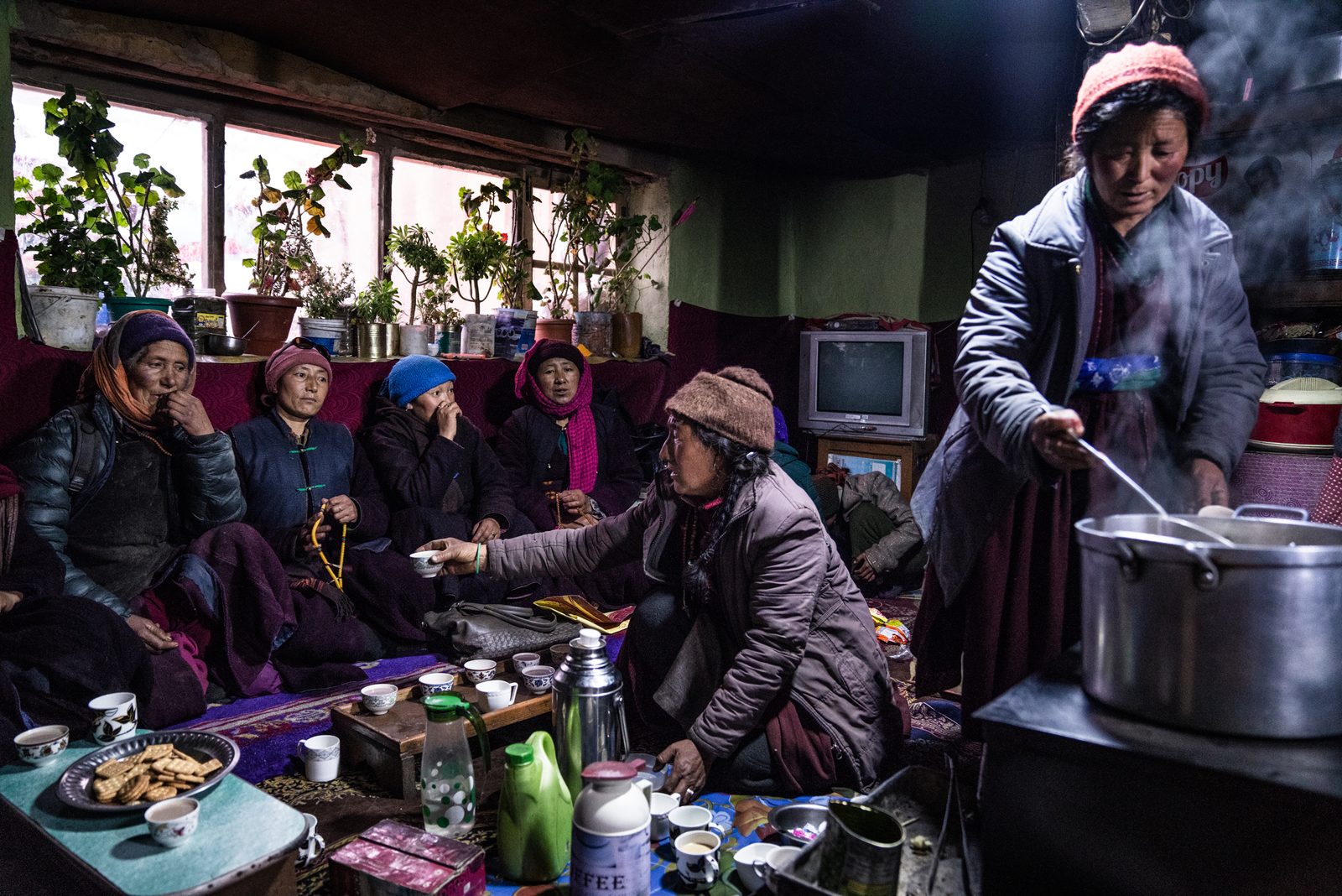 The women of Kumik gather inside Tsewang Zangmo's home after a funeral