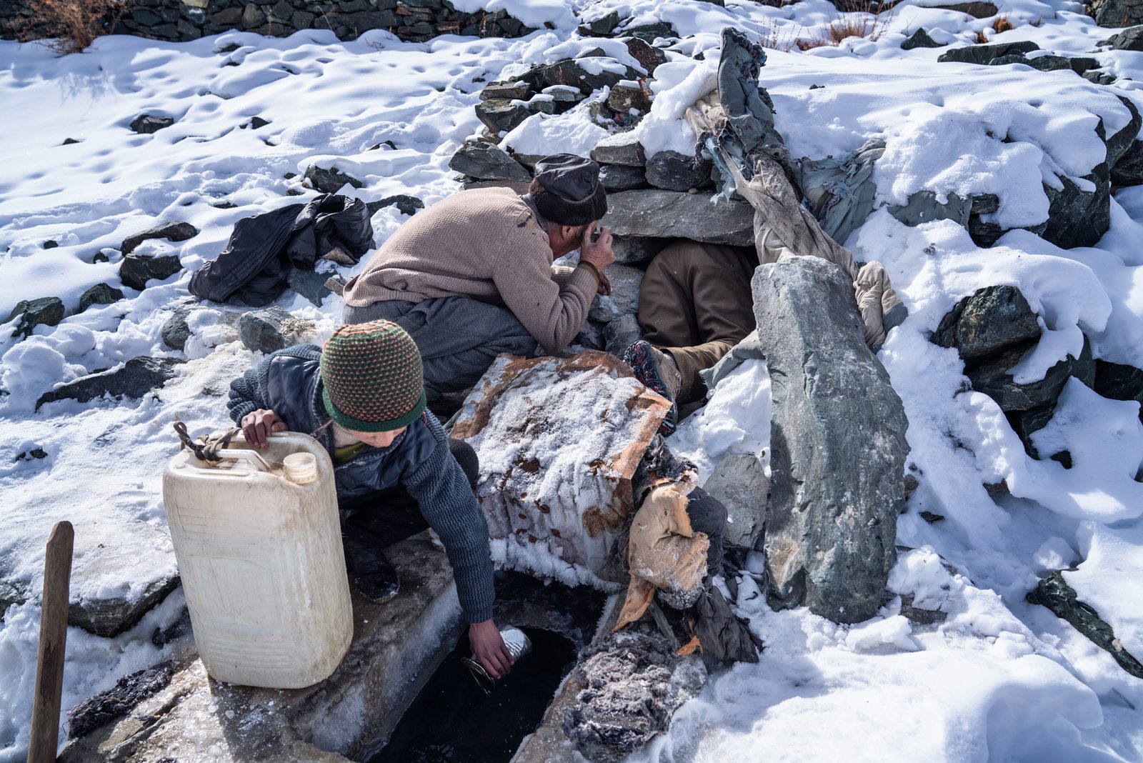 Tenzin Yangdoll fills up her jerry can with water from the only available spring