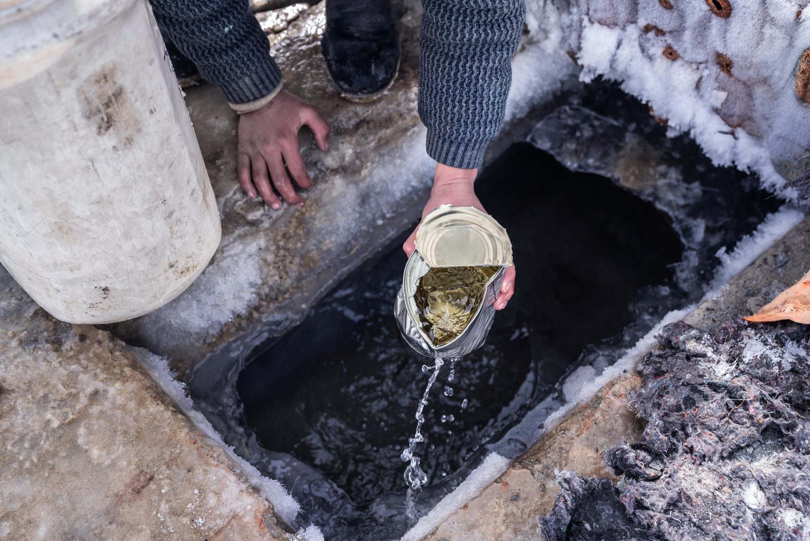 Villagers collect water from the spring