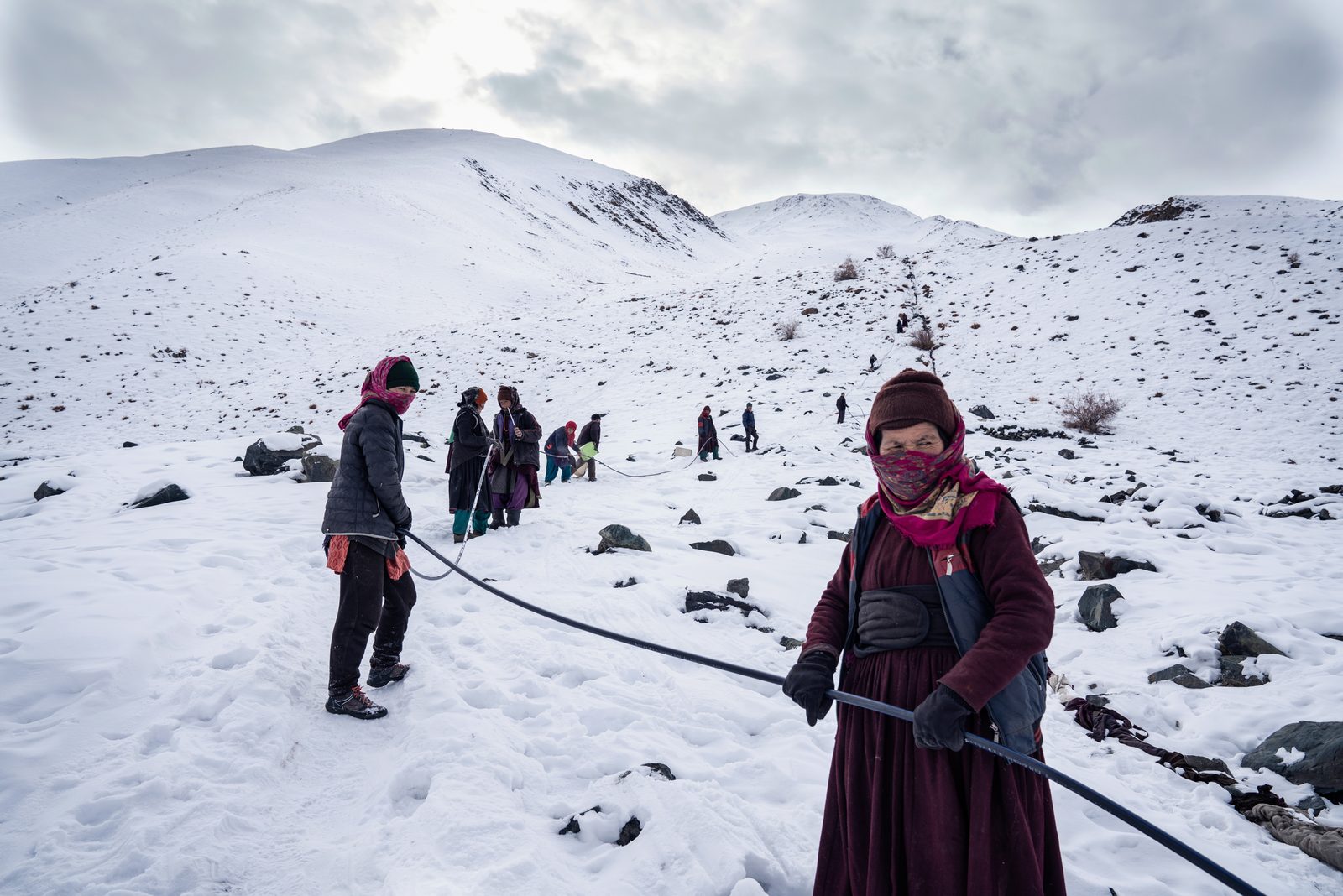 The villagers of Kumik work together and attempt to dislodge ice in the pipe