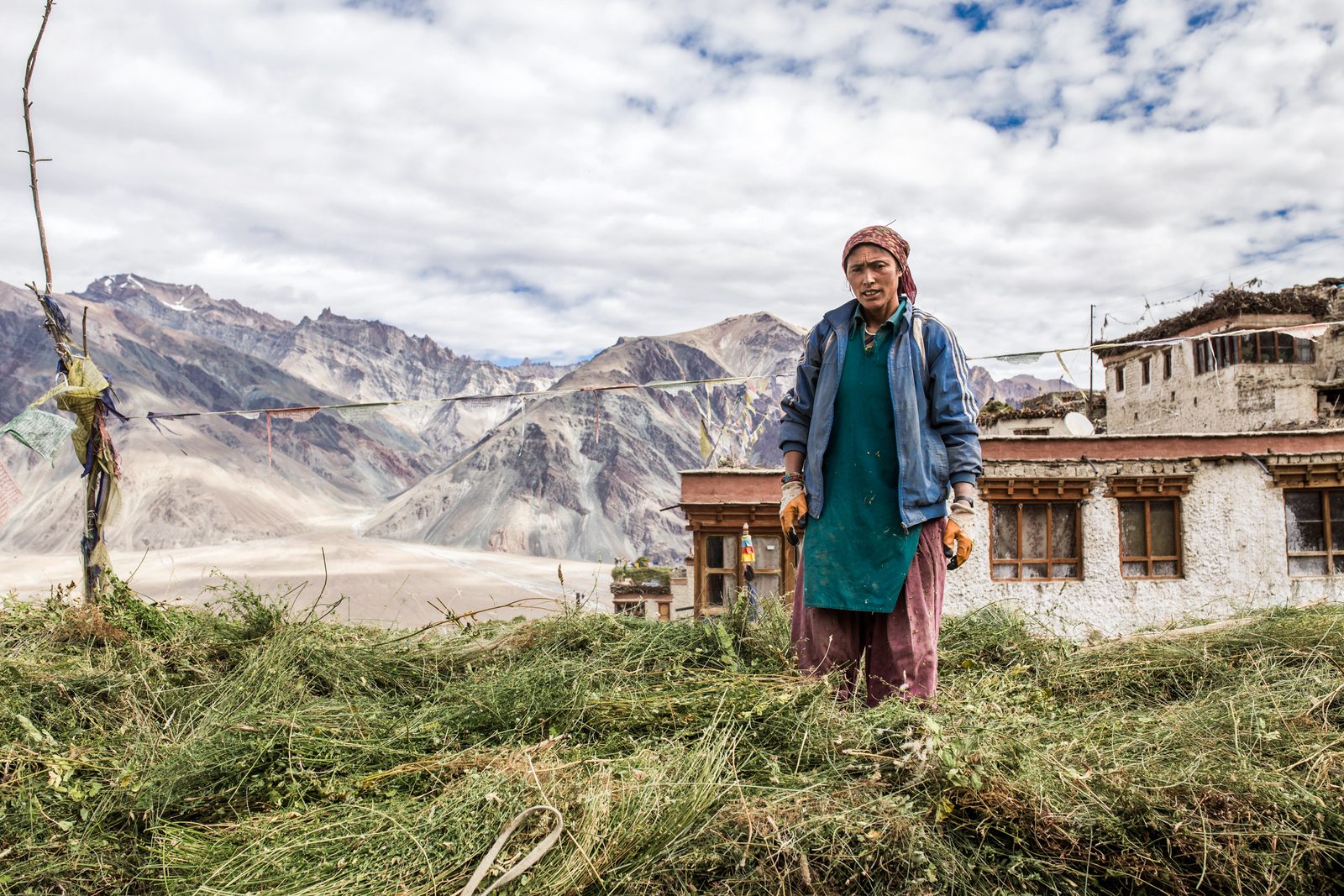 Tsewang Zangmo takes a break on the roof of her home after organising livestock fodder