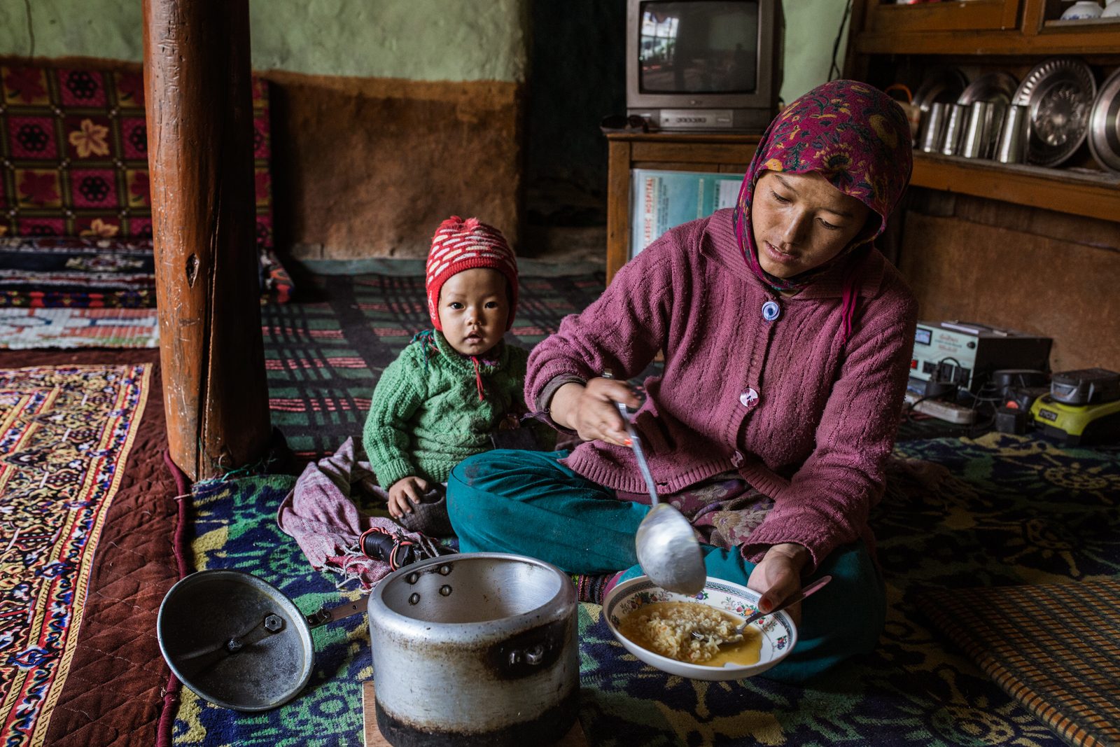 Lobsang Saldon serves lunch with her son by her side
