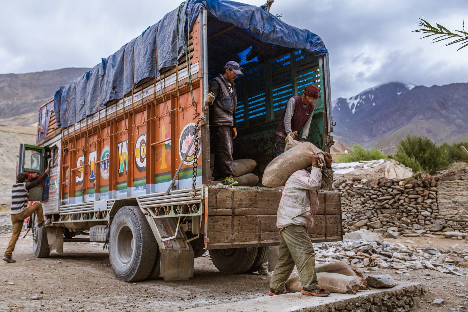 A villager carriers imported food supplies to storage