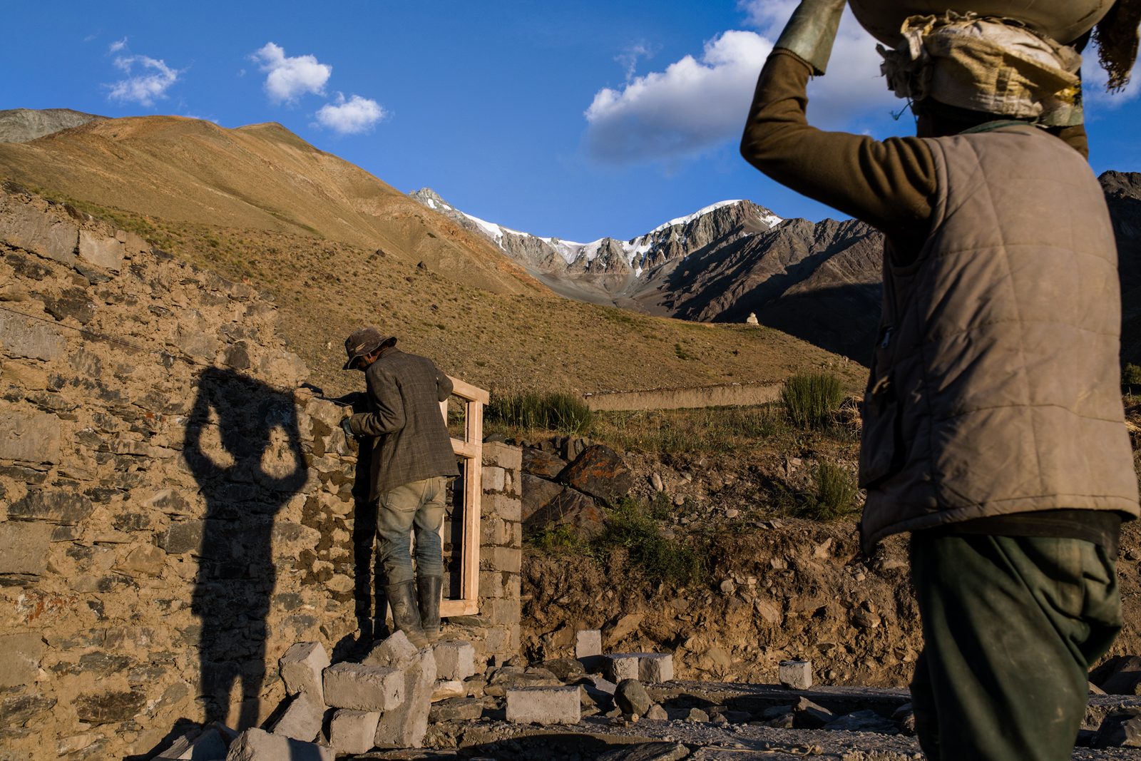 Villagers of Kumik construct a new home with Sultan Largo looming overhead