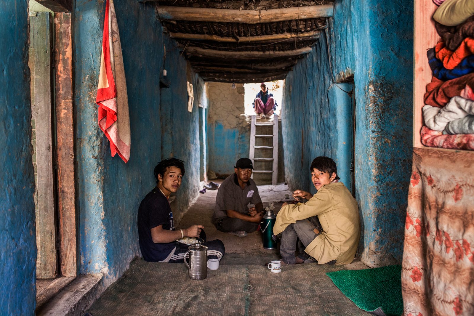 Tashi Stobdan and Tsewang Zangmo rest with seasonal workers from Nepal