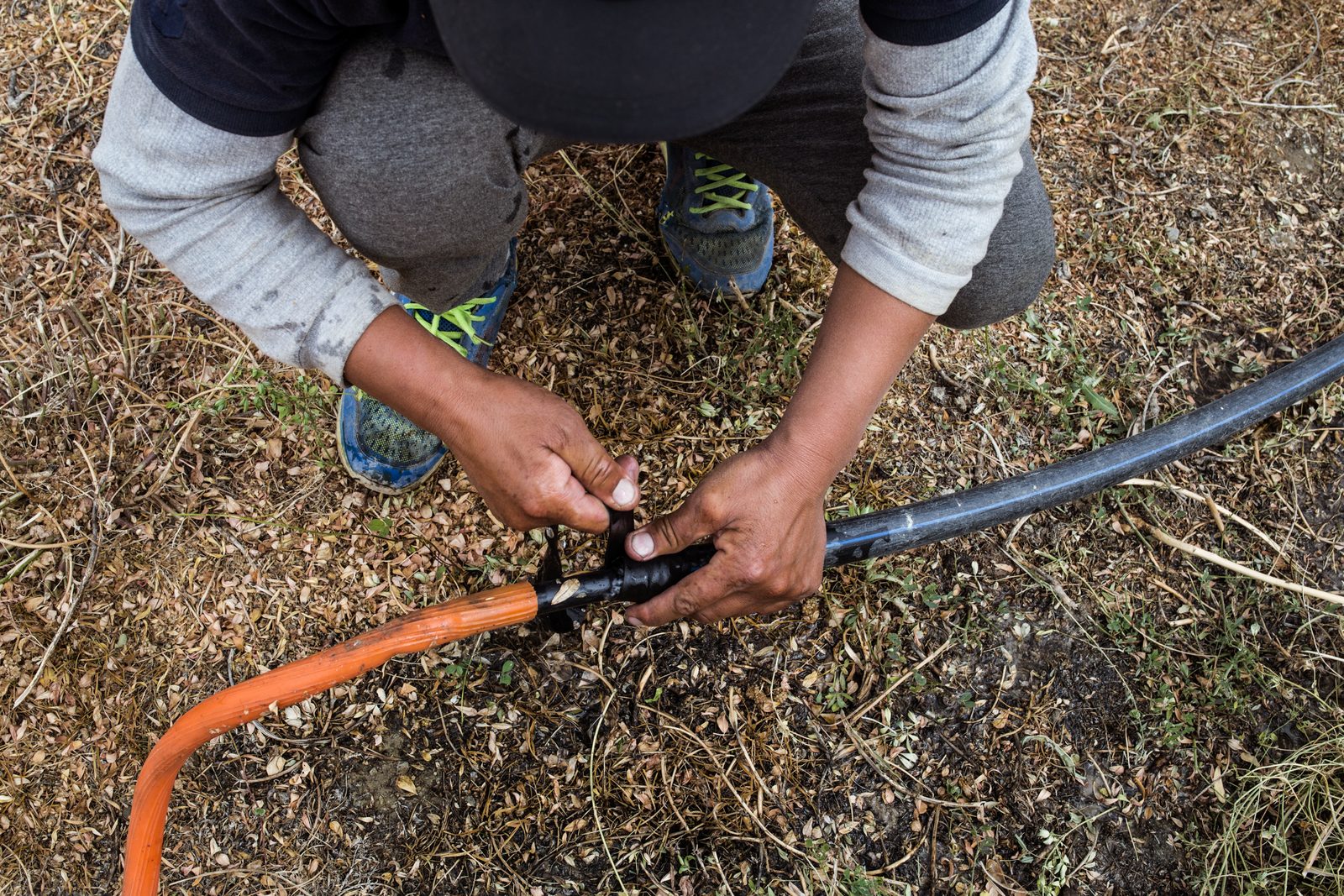 Tashi Stobdan attempts to fix a leaking pipe in Lower Kumik