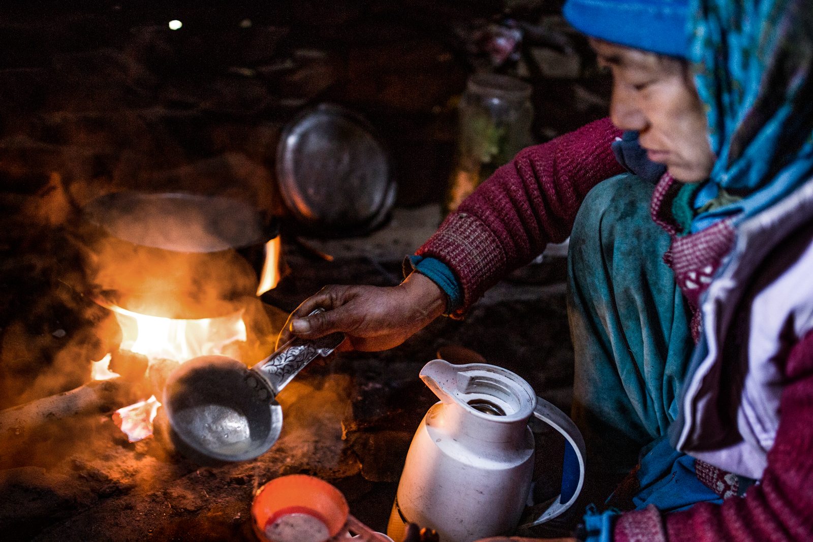 Fresh chai being prepared by a fire inside a shelter at the doksa