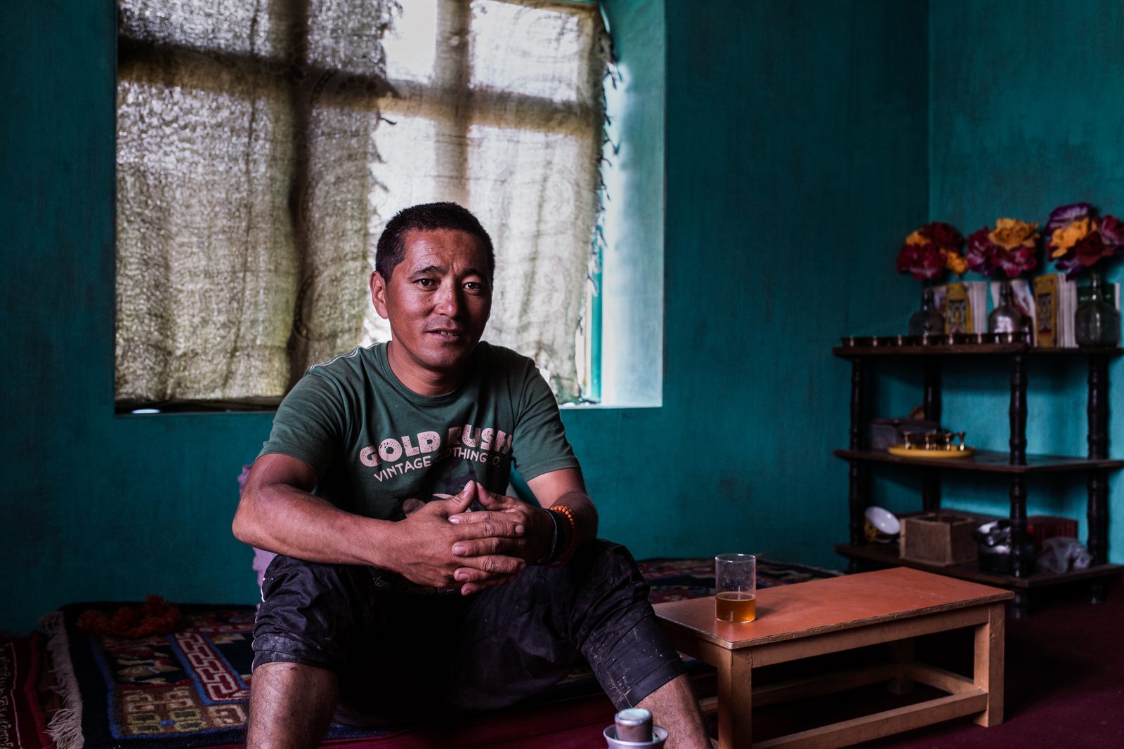 Bonchowk Chezin sits in his newly built home in Lower Kumik